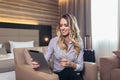 Attractive businesswoman in hotel room using digital tablet Royalty Free Stock Photo