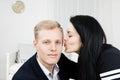 Young attractive businesswoman kissing man in formal dress