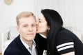 Young attractive businesswoman kissing man in formal dress