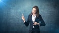 Young attractive businesswoman portrait in suit with standing and finger up, isolated studio background with copyspace. Royalty Free Stock Photo