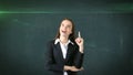 Young attractive businesswoman portrait in suit with standing and finger up, isolated studio background with copyspace. Royalty Free Stock Photo