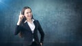 Young attractive businesswoman portrait in suit with standing and finger up, isolated studio background with copyspace. Royalty Free Stock Photo