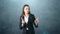 Young attractive businesswoman portrait in suit with standing and finger up, isolated studio background with copyspace. Royalty Free Stock Photo