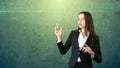 Young attractive businesswoman portrait in suit with standing and hand up, isolated studio background with copyspace. Royalty Free Stock Photo