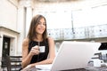 Businesswoman drinking coffee with laptop