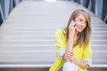 Young attractive businesswoman sitting on the stairs and using s Royalty Free Stock Photo