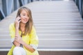Young attractive businesswoman sitting on the stairs and using smart phone. Royalty Free Stock Photo