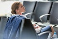 Young attractive businesswoman using smartphone while waiting for her flight in airport Royalty Free Stock Photo