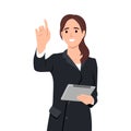 Young attractive businesswoman wearing formal suit is standing, holding tablet and touching air. Concept of contemporary Royalty Free Stock Photo