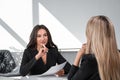 Young attractive businesswoman wearing formal suit is touching her chin Royalty Free Stock Photo