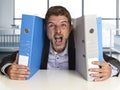 Young attractive busy businessman overwhelmed suffering crazy stress at office screaming desperate Royalty Free Stock Photo