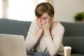 Young attractive and busy woman at home sofa couch doing some laptop computer work in stress looking worried in entrepreneur lifes Royalty Free Stock Photo