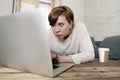 Young attractive and busy woman at home sofa couch doing some laptop computer work in stress looking worried in entrepreneur lifes Royalty Free Stock Photo