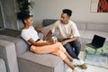 Young attractive casual African American couple thoughtfully discussing new project during coffee break in co-working Royalty Free Stock Photo