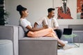 Young attractive casual African American couple thoughtfully talking during coffee break in co-working space Royalty Free Stock Photo