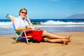 Young Attractive Casual Businessman Relaxing at the Beach Talking on Cell Phone Royalty Free Stock Photo