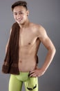 Young attractive caucasian man swimmer with goggles and towel is Royalty Free Stock Photo