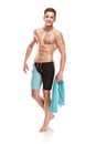 Young attractive caucasian man swimmer with goggles and towel