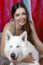 Young attractive caucasian woman embrases expressive dog of big swiss shepherd breed. Beautiful female and snowy white dog like Gh Royalty Free Stock Photo