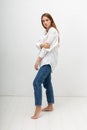 young attractive caucasian woman with long brown hair in shirt, blue jeans Royalty Free Stock Photo