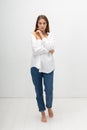young attractive caucasian woman with long brown hair in shirt, blue jeans Royalty Free Stock Photo