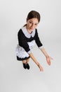 Young attractive chambermaid in uniform showing spotless floor isolated over white background