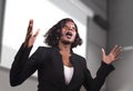 Young attractive and confident black African American business woman with headset speaking in auditorium at corporate training Royalty Free Stock Photo