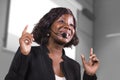 Young attractive and confident black African American business woman with headset speaking in auditorium at corporate training Royalty Free Stock Photo