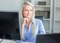 Young, attractive and confident business woman working in office Royalty Free Stock Photo