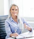 Young, attractive and confident business woman working in office Royalty Free Stock Photo