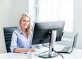 Young, attractive and confident business woman working in office Royalty Free Stock Photo