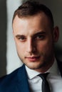 Young attractive and confident businessman in blue suit and black tie. Royalty Free Stock Photo