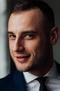 Young attractive and confident businessman in blue suit and black tie. Royalty Free Stock Photo