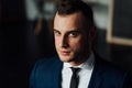 Young attractive and confident businessman in blue suit and black tie. Royalty Free Stock Photo