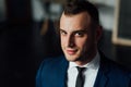 Young attractive and confident businessman in blue suit and black tie. Royalty Free Stock Photo