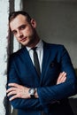 Young attractive and confident businessman in blue suit and black tie. Royalty Free Stock Photo