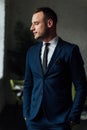 Young attractive and confident businessman in blue suit and black tie. Royalty Free Stock Photo