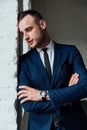 Young attractive and confident businessman in blue suit and black tie. Royalty Free Stock Photo