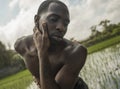 Young attractive contemporary ballet dancer and choreographer , a black African American man dancing and posing on tropical rice Royalty Free Stock Photo