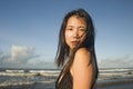 Young attractive and cool Asian Korean woman in swimsuit walking on beautiful beach paradise feeling relaxed enjoying holidays in Royalty Free Stock Photo