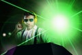 Young attractive and cool DJ in shirt and suspenders remixing music at night club using headphones in party strobo and laser Royalty Free Stock Photo