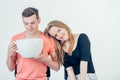 Young attractive couple on date in coffee shop with big coffee cup Royalty Free Stock Photo