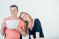 Young attractive couple on date in coffee shop with big coffee cup Royalty Free Stock Photo