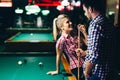 Young attractive couple on date in snooker club