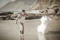 Young attractive couple flirting along beach wearing white Royalty Free Stock Photo