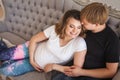 Young attractive couple, future parents hugging on sofa in studio Royalty Free Stock Photo