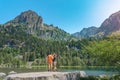 Young Attractive Couple holding hands in a Beautiful Lake in the mountains in summer during sunset. Discovery Travel Royalty Free Stock Photo