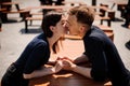 Young and attractive couple holding hands about to kiss over table in restaurant Royalty Free Stock Photo