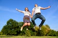 Jumping couple. Fun day outdoor