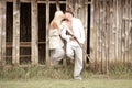 Young attractive couple kissing against wooden barn wall Royalty Free Stock Photo